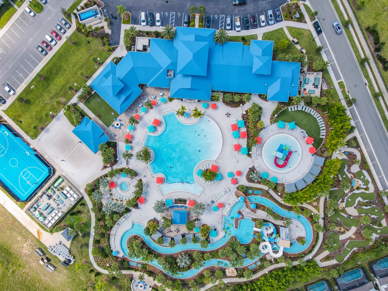 Aerial view of a resort clubhouse, pool and lazy river in a Central Florida vacation rental community
